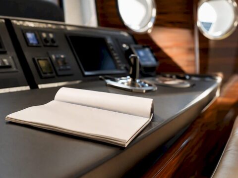Travel insurance papers on yacht navigation console
