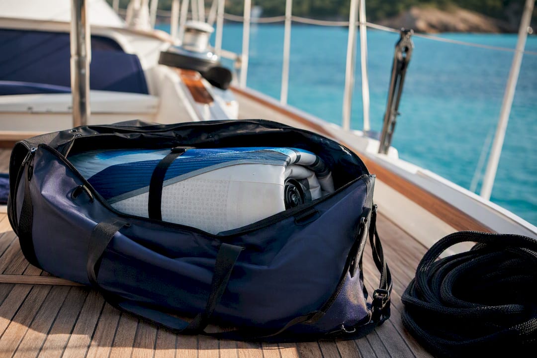 Inflatable SUP packed in duffel on yacht deck