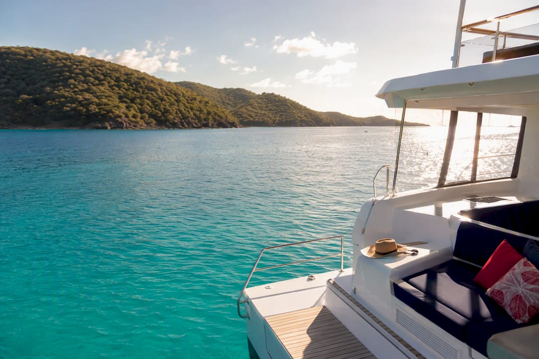 Luxury power catamaran anchored in turquoise tropical bay