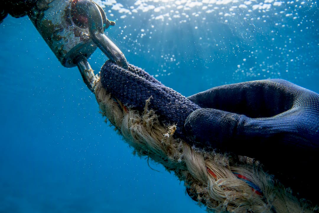 Diver inspecting worn mooring pendant