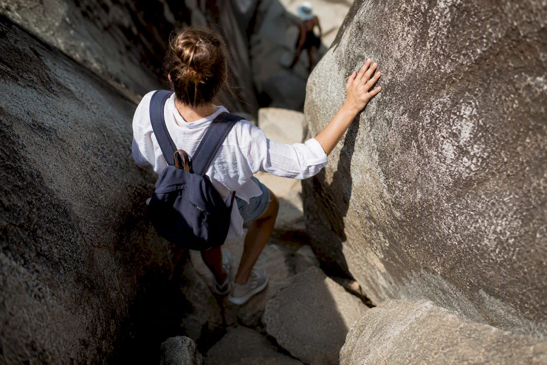 Visitor navigating The Baths boulder trail
