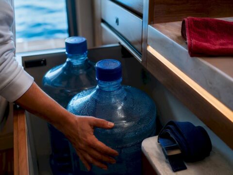 Large water jugs secured in yacht storage
