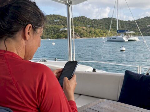 Guest checking a mooring reservation aboard a yacht