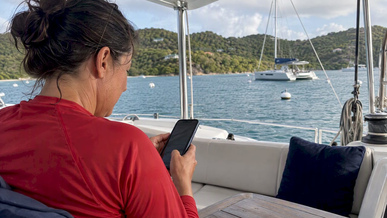 Guest checking a mooring reservation aboard a yacht