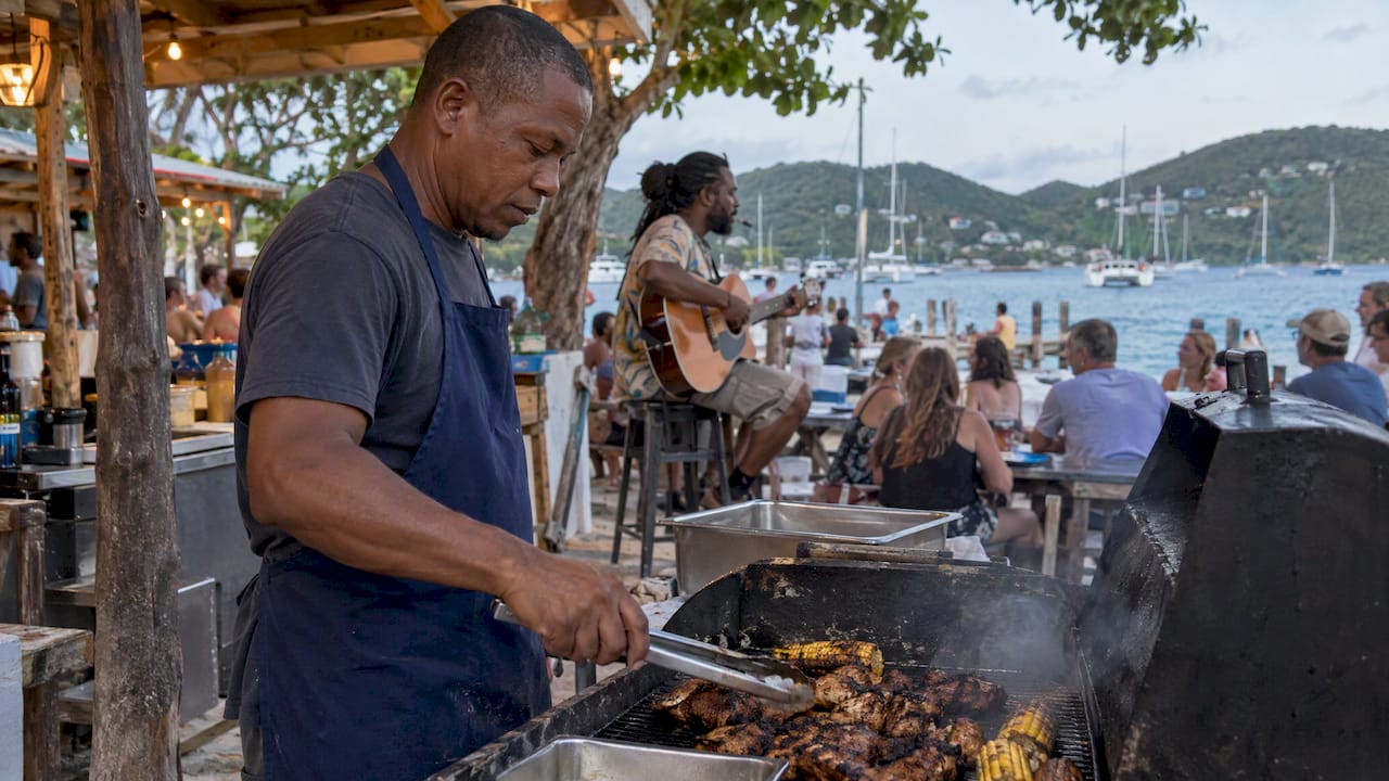 Cook tending a beach barbecue beside live music