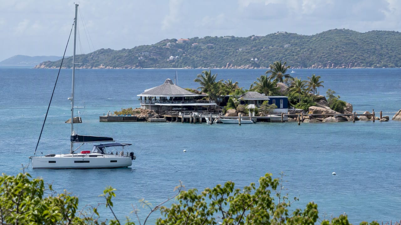 Saba Rock islet and yacht in North Sound