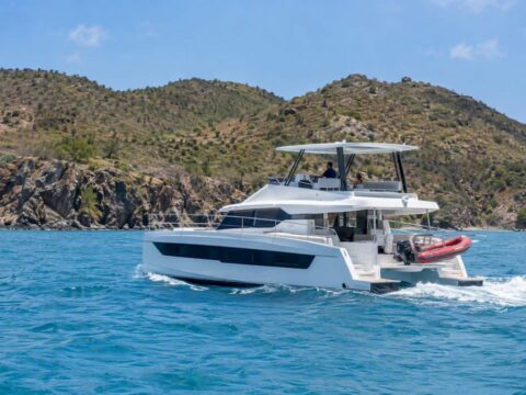 Charter catamaran cruising beside Norman Island