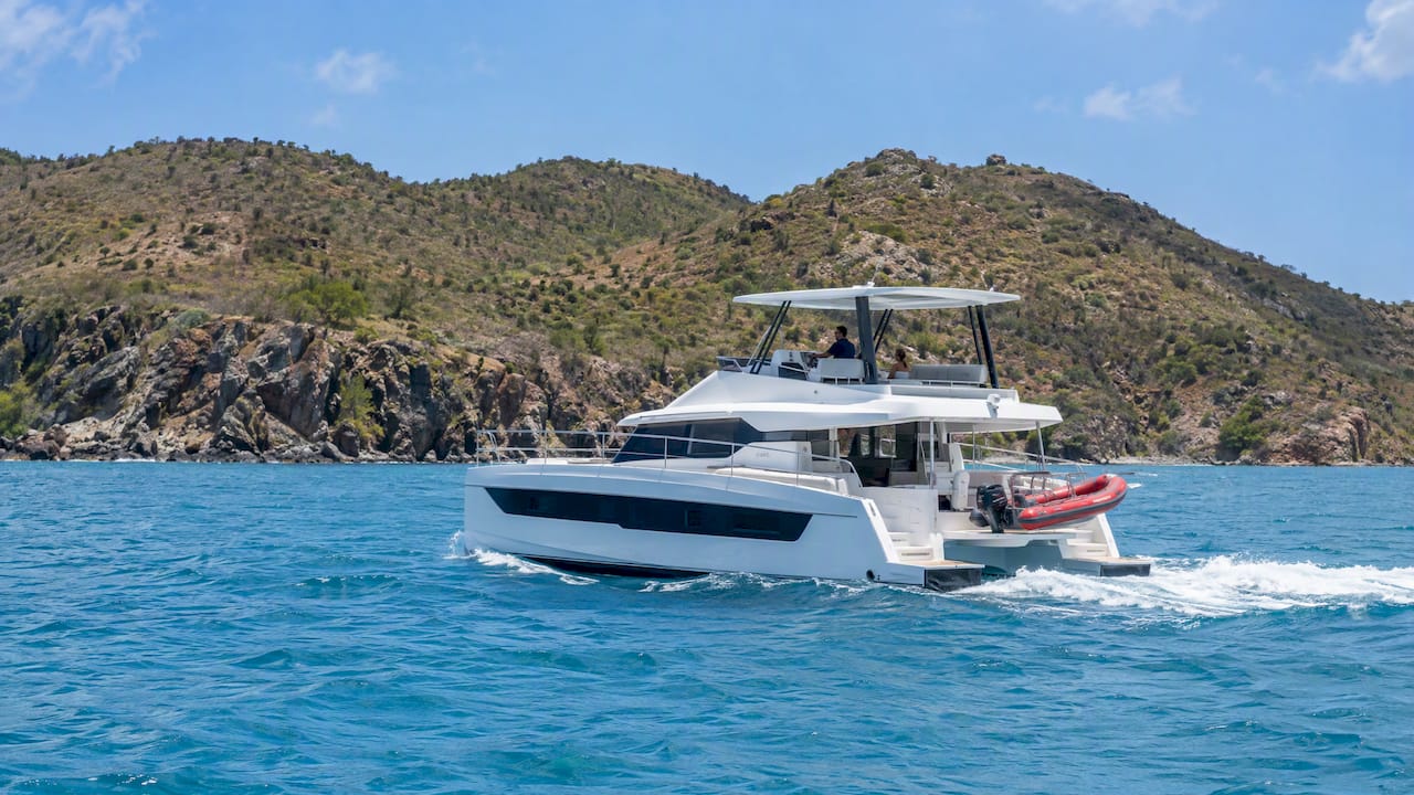 Charter catamaran cruising beside Norman Island